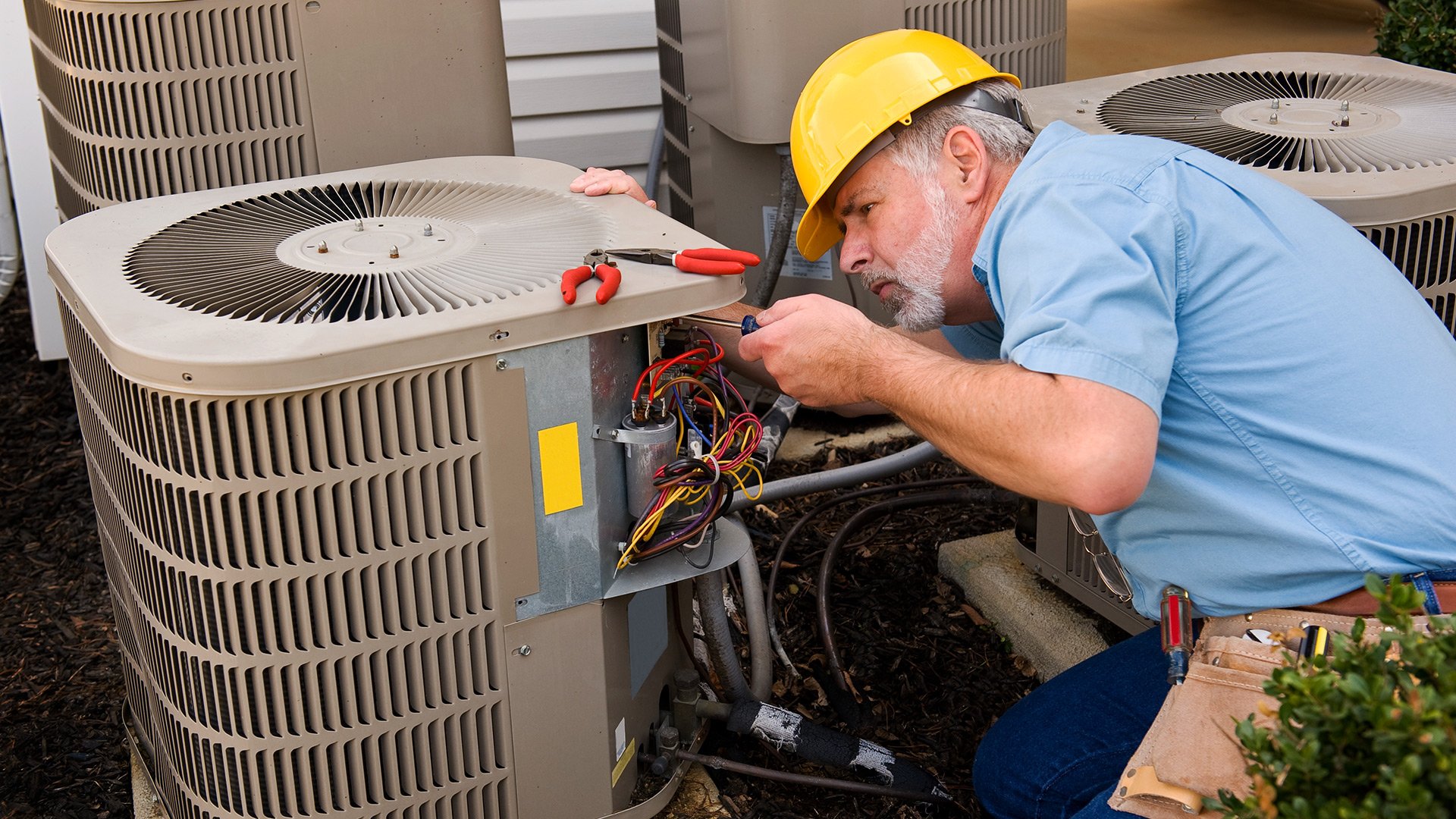 Man working on A/C unit